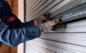 expert repairing misaligned garage door track
