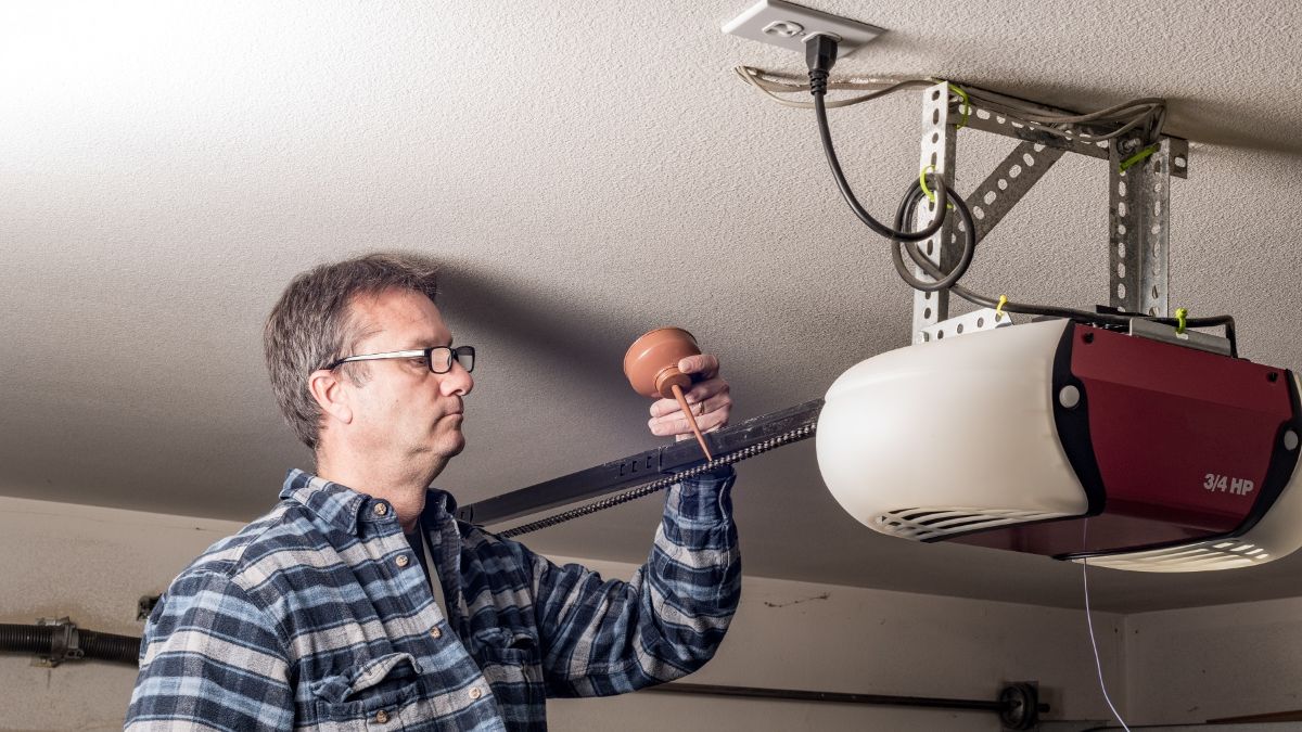 expert working on a garage door opener